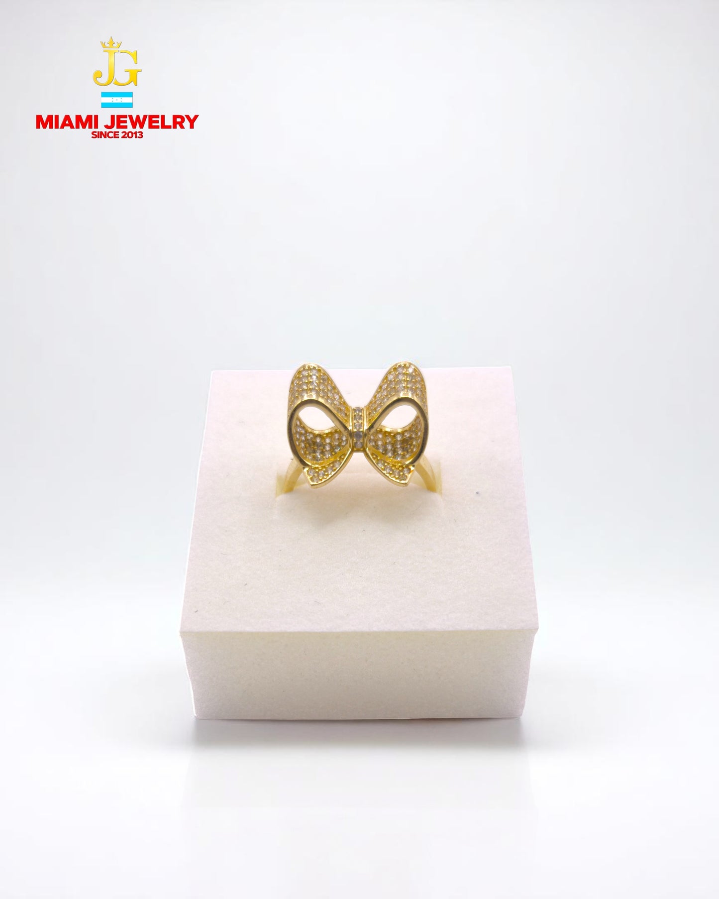 Solid 14k yellow gold bow with white-zirconia gemstones