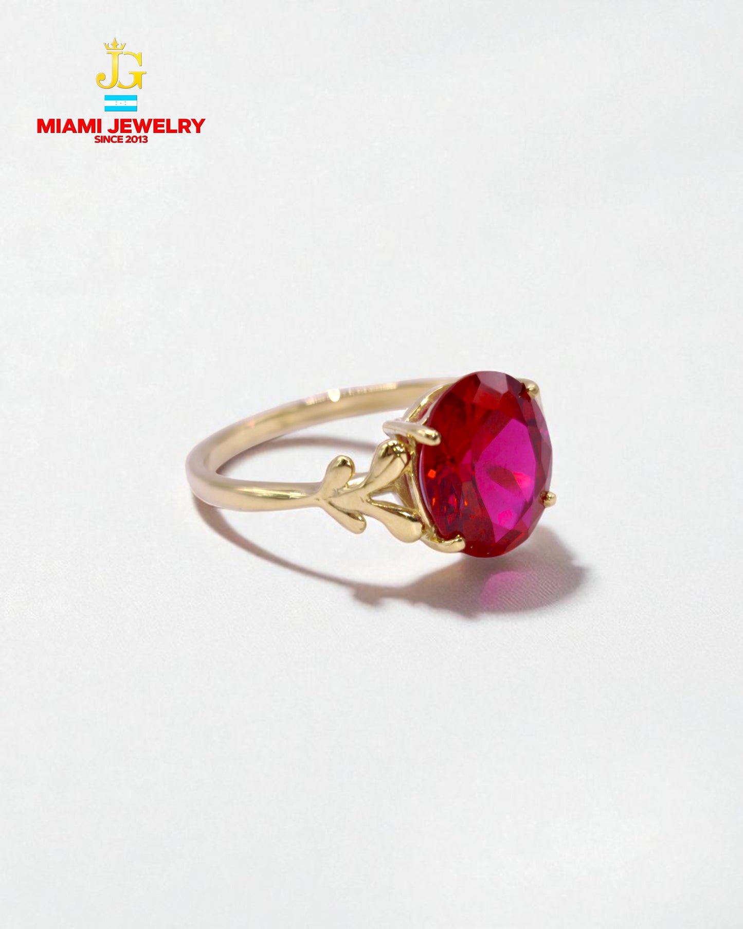 Solid 14k yellow gold oval-cut pink stone.